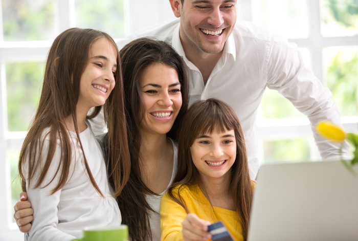 Happy family looking at laptop